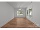 The dining room has wood flooring and a modern light fixture at 108 Woodwinds St, Locust, NC 28097