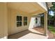 Covered porch featuring neutral siding, white trim, and large windows at 108 Woodwinds St, Locust, NC 28097