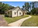 Charming home exterior with landscaped yard and a winding walkway at 108 Woodwinds St, Locust, NC 28097