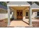 Close up of double door front entrance showing craftsman style elements and manicured landscaping at 108 Woodwinds St, Locust, NC 28097