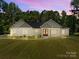 Charming single-story home featuring a landscaped yard, craftsman style architecture, and inviting front entrance at 108 Woodwinds St, Locust, NC 28097
