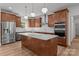 The kitchen features stainless steel appliances, custom cabinets, an island with countertop, and hardwood floors at 108 Woodwinds St, Locust, NC 28097