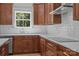 Kitchen features custom cabinets, granite countertops, stainless steel appliances, and tile backsplash at 108 Woodwinds St, Locust, NC 28097