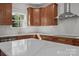 Kitchen features granite countertops, stainless steel appliances, wood cabinets, and tile backsplash at 108 Woodwinds St, Locust, NC 28097