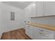 Bright laundry room with white cabinets, ample countertop space, and modern appliances at 108 Woodwinds St, Locust, NC 28097