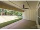 Covered patio with a ceiling fan overlooking a spacious, well-kept backyard at 108 Woodwinds St, Locust, NC 28097