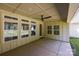 Covered patio with ceiling fan and recessed lighting with a view of the wooded yard at 108 Woodwinds St, Locust, NC 28097