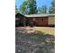 Rear exterior view of the home featuring wooden and brick elements at 11204 Williams Rd, Mint Hill, NC 28227