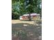 Charming one-story brick home featuring a spacious front yard and mature trees at 11204 Williams Rd, Mint Hill, NC 28227