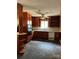 An outdated kitchen featuring cabinets, a window and a ceiling fan at 11204 Williams Rd, Mint Hill, NC 28227