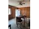 Living room showing the open entry door, wood paneling and ceiling fan at 11204 Williams Rd, Mint Hill, NC 28227