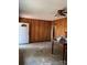 Living room showing the open entry door, wood paneling and ceiling fan at 11204 Williams Rd, Mint Hill, NC 28227