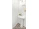 Powder room featuring stylish pedestal sink, octagonal mirror, and updated fixtures at 11712 Avocet St # 76, Charlotte, NC 28215