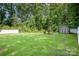 Large backyard with fence, storage shed and lush greenery at 1189 Quiet Acres Rd, Rock Hill, SC 29732