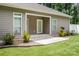 A charming home exterior features a concrete patio, lush green lawn, and neutral siding at 1189 Quiet Acres Rd, Rock Hill, SC 29732