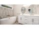 Bathroom with tub, dual sink vanity, modern fixtures, and decorative tile at 1189 Quiet Acres Rd, Rock Hill, SC 29732