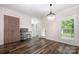 Spacious dining area with hardwood floors, modern lighting fixture, and a view to the backyard at 1189 Quiet Acres Rd, Rock Hill, SC 29732