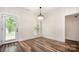 Bright dining area with modern chandelier, wood floors, a door to the outside, and a large window at 1189 Quiet Acres Rd, Rock Hill, SC 29732