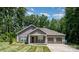 Inviting single-story home featuring a three-car garage, well-maintained lawn, and classic design at 1189 Quiet Acres Rd, Rock Hill, SC 29732