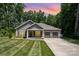 Beautiful exterior view showcasing a home with a well manicured lawn and 3 car garage at 1189 Quiet Acres Rd, Rock Hill, SC 29732