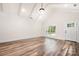 Bright living room with vaulted ceilings, hardwood floors, a large window, and an entry door at 1189 Quiet Acres Rd, Rock Hill, SC 29732