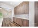 Kitchen pantry with custom cabinets, marble backsplash, modern hardware, and hardwood floors at 1189 Quiet Acres Rd, Rock Hill, SC 29732