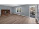 Bright living room featuring a red brick fireplace and warm, light-toned laminate flooring at 1229 Jenkins St, Rock Hill, SC 29732