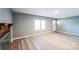 Bright living room featuring a brick fireplace, light-toned laminate flooring, and neutral gray walls at 1229 Jenkins St, Rock Hill, SC 29732