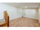 Upstairs living room boasts wood laminate flooring, staircase, and neutral paint at 1295 Reservation Rd, Rock Hill, SC 29730