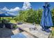 Outdoor patio area features an outdoor sink, stone countertop, and a beautiful view of the well-maintained backyard at 134 Cherry Bark Dr, Mooresville, NC 28117