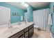 Clean bathroom featuring double sinks, a large mirror, and a shower with a blue and white striped curtain at 134 Cherry Bark Dr, Mooresville, NC 28117