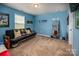 Spacious bonus room with a futon, motivational decor, and a full-length mirror for a home gym at 134 Cherry Bark Dr, Mooresville, NC 28117