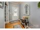 Welcoming entryway features hardwood floors, a decorative mirror, and a charming bench with storage basket at 134 Cherry Bark Dr, Mooresville, NC 28117