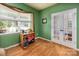 Bright home office with large windows, hardwood floors, and a functional desk perfect for remote work at 134 Cherry Bark Dr, Mooresville, NC 28117