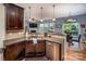 Well-appointed kitchen with stainless steel dishwasher, sink, granite counters and open view to dining area at 134 Cherry Bark Dr, Mooresville, NC 28117