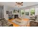 Cozy living room featuring a fireplace, hardwood floors, and large windows that provide ample natural light at 134 Cherry Bark Dr, Mooresville, NC 28117