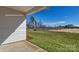 View of backyard featuring healthy green grass and partial view of new home at 159 Apple Orchard Ct, Statesville, NC 28677