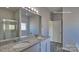 This primary bathroom has a double vanity, a shower with glass doors, and granite countertops at 159 Apple Orchard Ct, Statesville, NC 28677