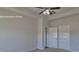 A neutral-painted bedroom with carpet, ceiling fan, and two storage closets at 159 Apple Orchard Ct, Statesville, NC 28677