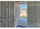View of an open doorway, brick exterior, and doormat in a well-lit foyer at 159 Apple Orchard Ct, Statesville, NC 28677
