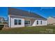 Exterior view of a new home with healthy grass and a neutral color palette at 159 Apple Orchard Ct, Statesville, NC 28677