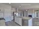 Kitchen with stainless steel appliances, granite countertops, and center island with a view to the living room at 159 Apple Orchard Ct, Statesville, NC 28677