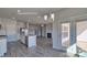 Open kitchen with island, stainless steel appliances, and plenty of natural light flowing to the outdoor patio at 159 Apple Orchard Ct, Statesville, NC 28677