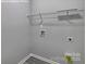 Bright laundry room features gray walls, durable gray flooring, utility connections and a wire rack shelving system at 159 Apple Orchard Ct, Statesville, NC 28677