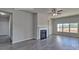 Bright living room featuring a fireplace, wood-style floors, and large windows for natural light at 159 Apple Orchard Ct, Statesville, NC 28677