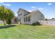 A meticulously maintained backyard featuring green lawn, beautiful shrubbery, and white fencing at 159 E Warfield Dr, Mooresville, NC 28115