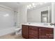 Bright bathroom featuring double sink vanity, shower-tub combination and tile flooring at 159 E Warfield Dr, Mooresville, NC 28115