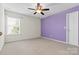 Bright bedroom featuring plush carpeting, ceiling fan and neutral wall paint at 159 E Warfield Dr, Mooresville, NC 28115