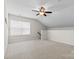 Bonus room featuring a ceiling fan, natural light, and neutral carpet at 159 E Warfield Dr, Mooresville, NC 28115