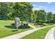 Well maintained community space featuring sidewalk access, lending library, and playground in the background at 159 E Warfield Dr, Mooresville, NC 28115